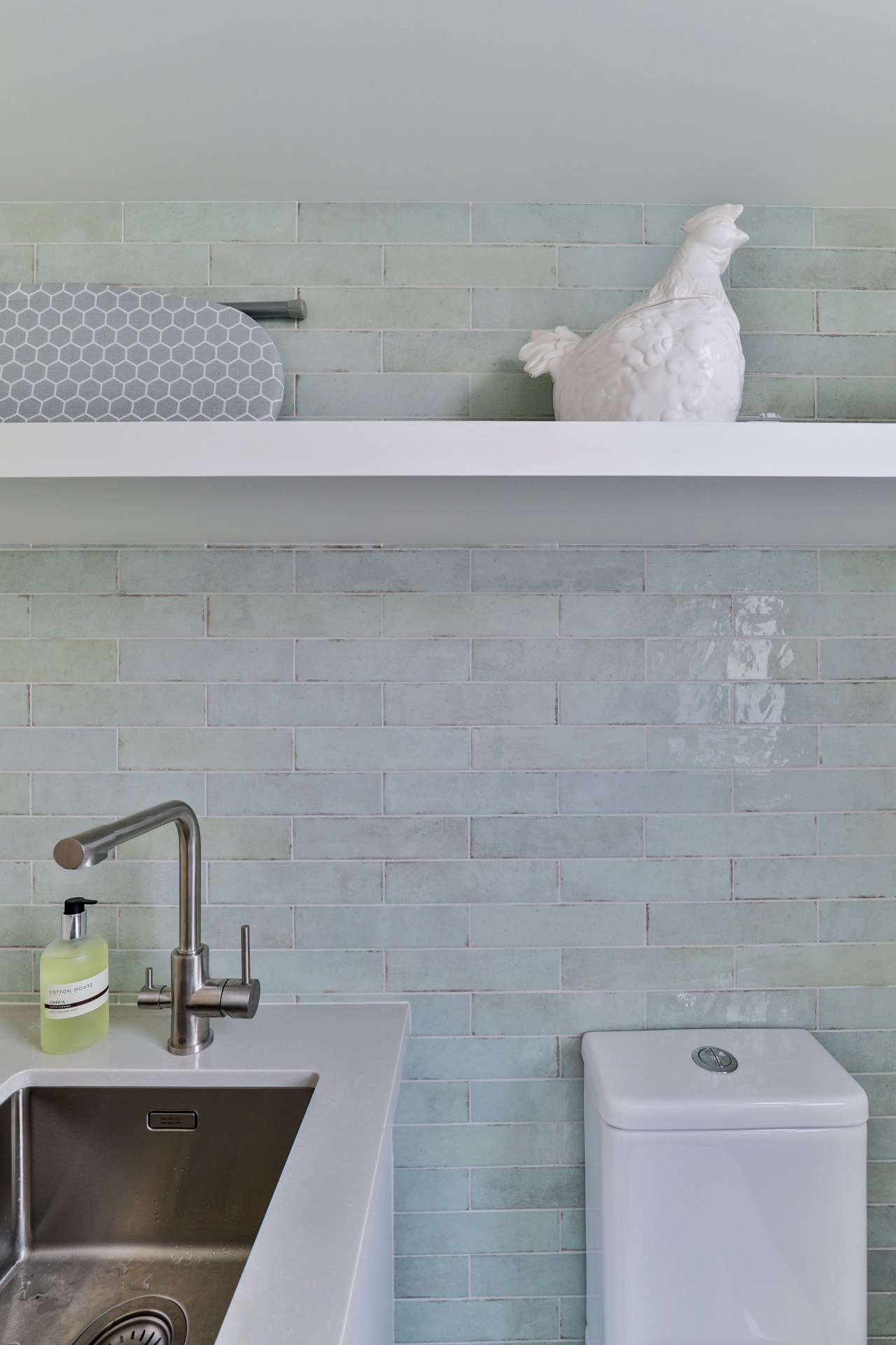 Feature Tribeca Seaglass Mint tiles complete this laundry/mixed 