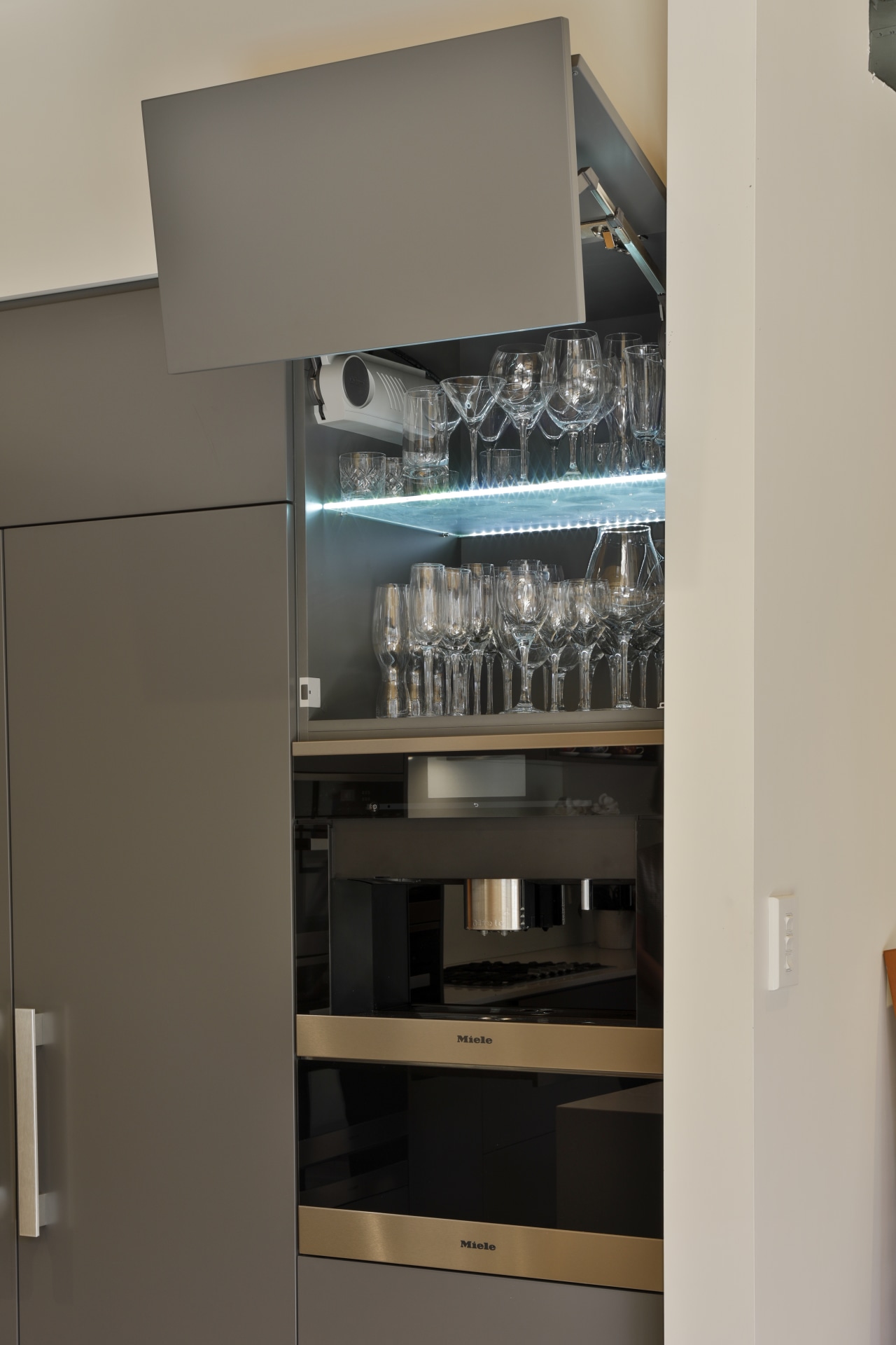 Blum Aventos HF hardware lets this high cabinet 