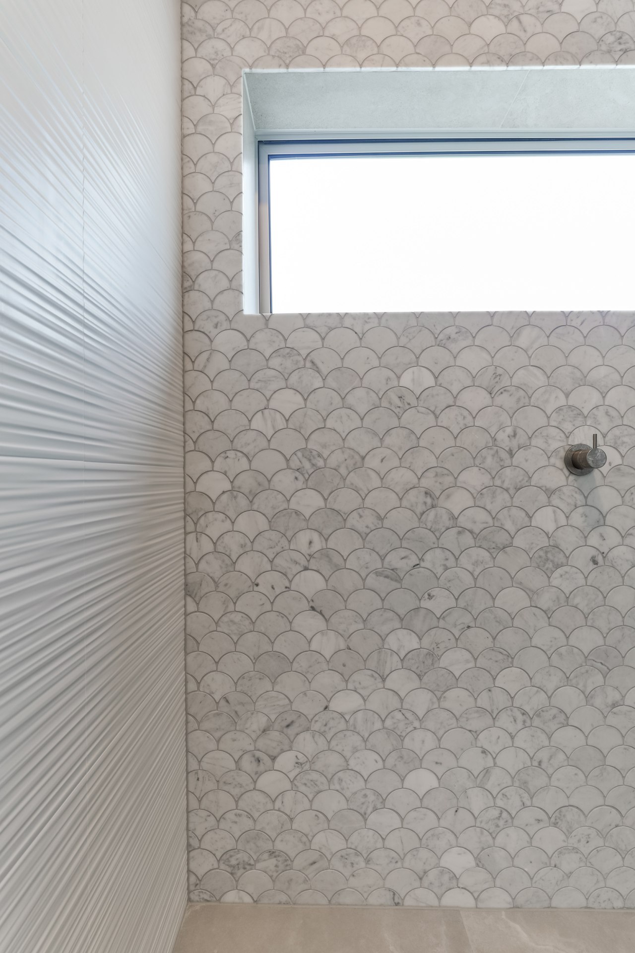 The Fish Scale mosaics cut from honed Carrara 