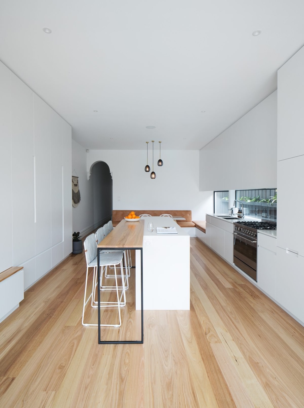 This kitchen features ample storage and dining space architecture, ceiling, daylighting, floor, flooring, hardwood, house, interior design, laminate flooring, property, real estate, wood, wood flooring, white