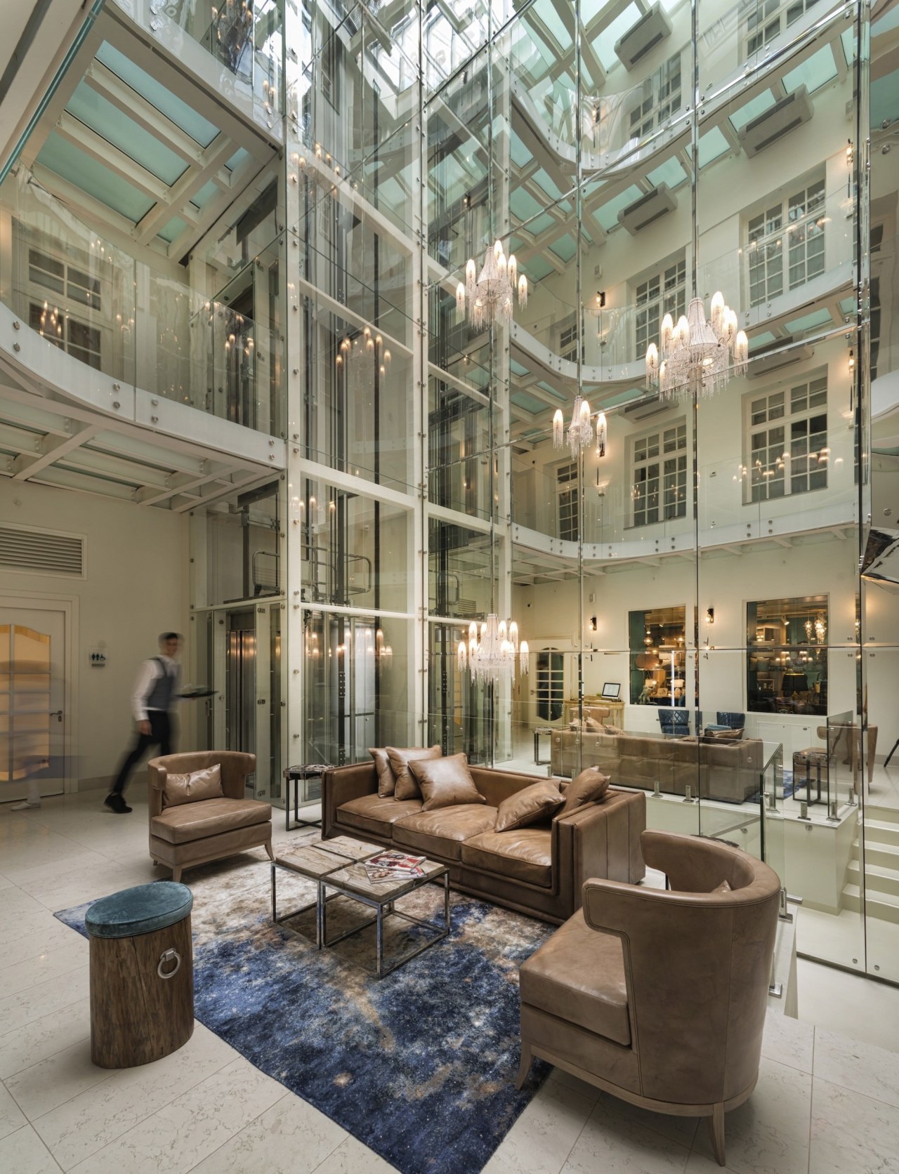 The atrium is a melding of the old daylighting, interior design, lobby, mixed use, gray