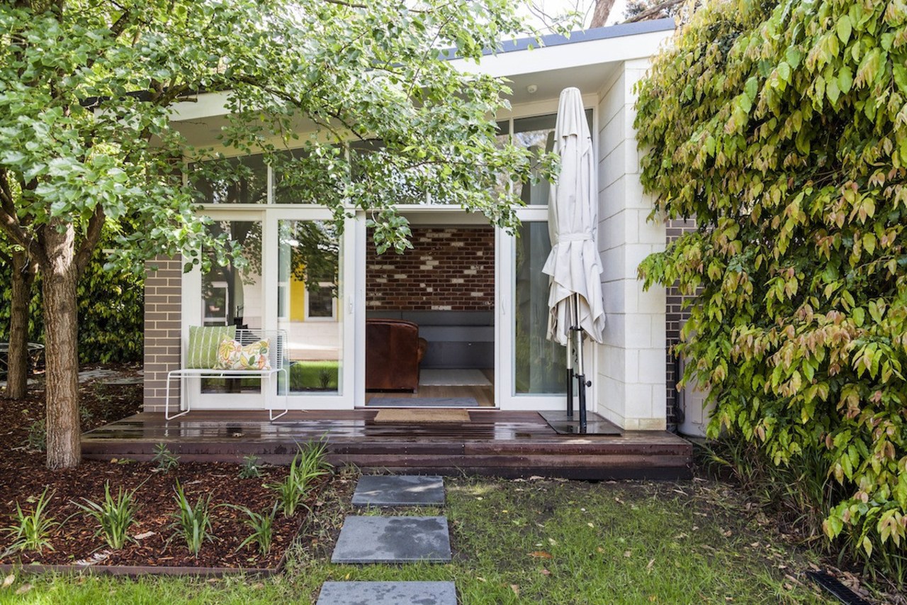 There's excellent indoor/outdoor flow architecture, backyard, cottage, courtyard, home, house, outdoor structure, property, real estate, yard, brown