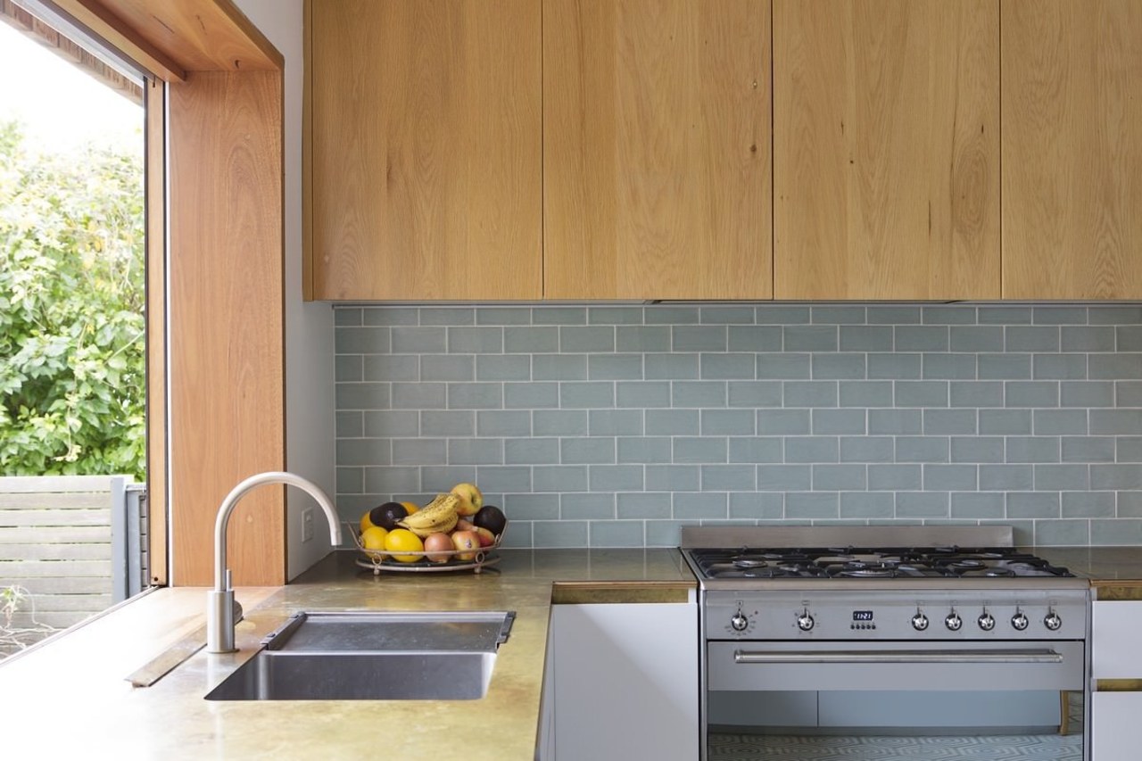 An under-cabinet rangehood maintains a clean look in architecture, countertop, floor, flooring, home, interior design, kitchen, real estate, tile, wall, gray