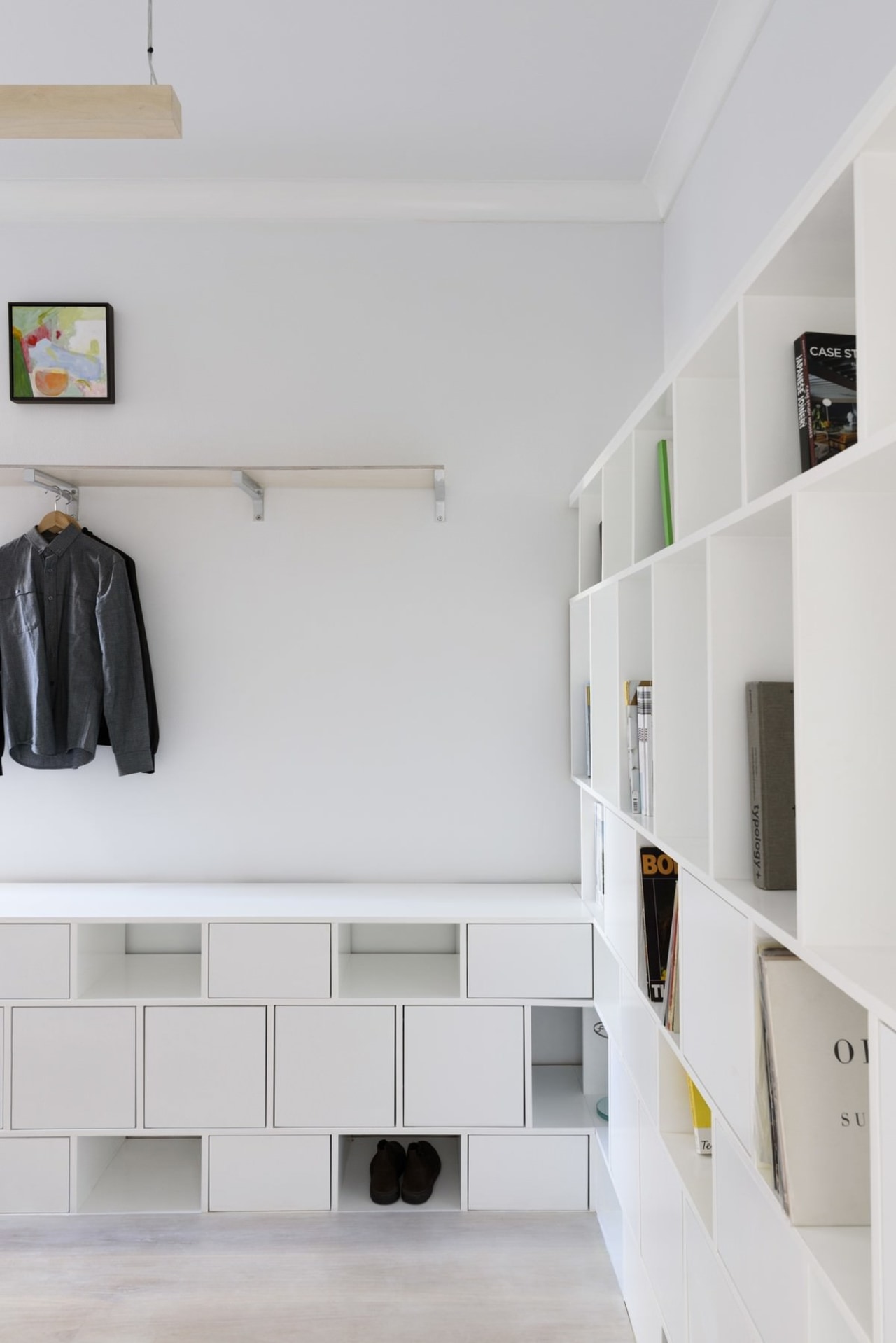 There's room for shoes, coats, books and more architecture, floor, furniture, interior design, product design, room, shelf, shelving, wall, gray