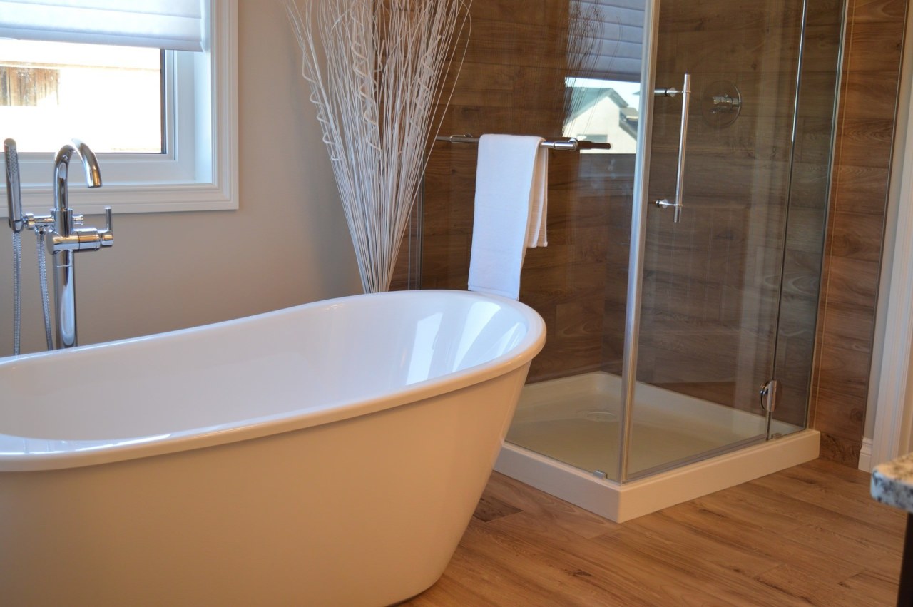 This freestanding tub makes the bathroom feel significantly bathroom, bathtub, floor, flooring, interior design, plumbing fixture, room, tile, brown, gray