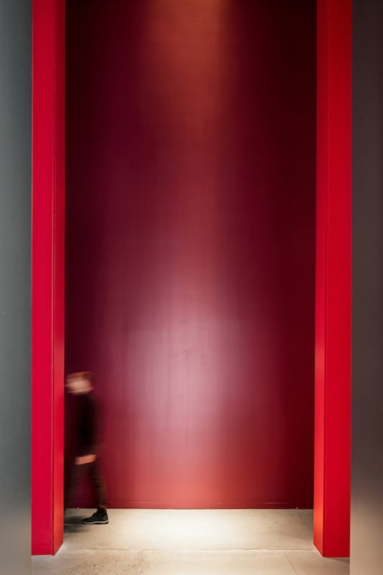 This massive doorway is certainly imposing door, floor, interior design, light, lighting, red, wall, red
