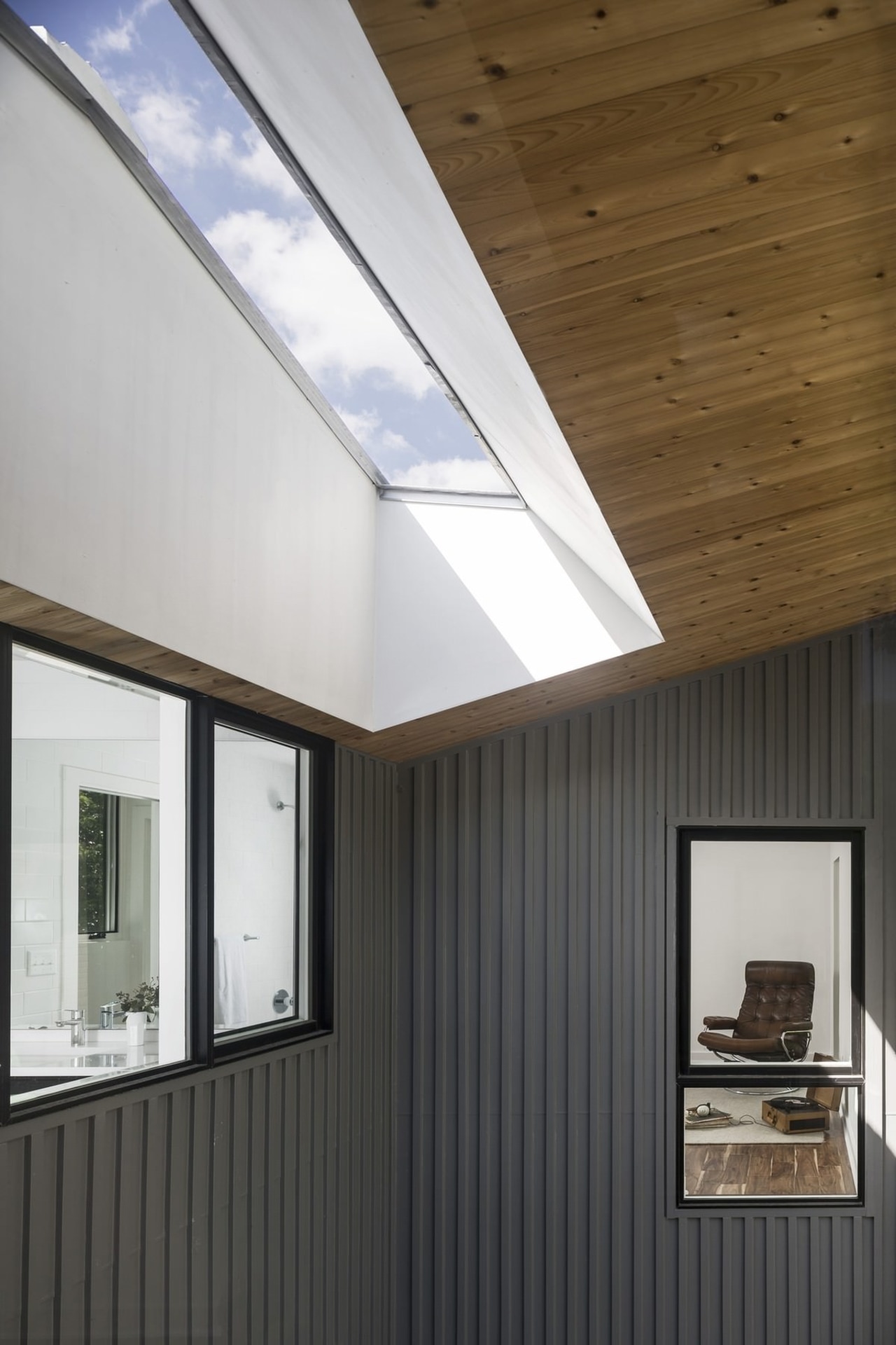 A skylight merges with the soffit architecture, ceiling, daylighting, home, house, interior design, lighting, real estate, roof, window, white, black