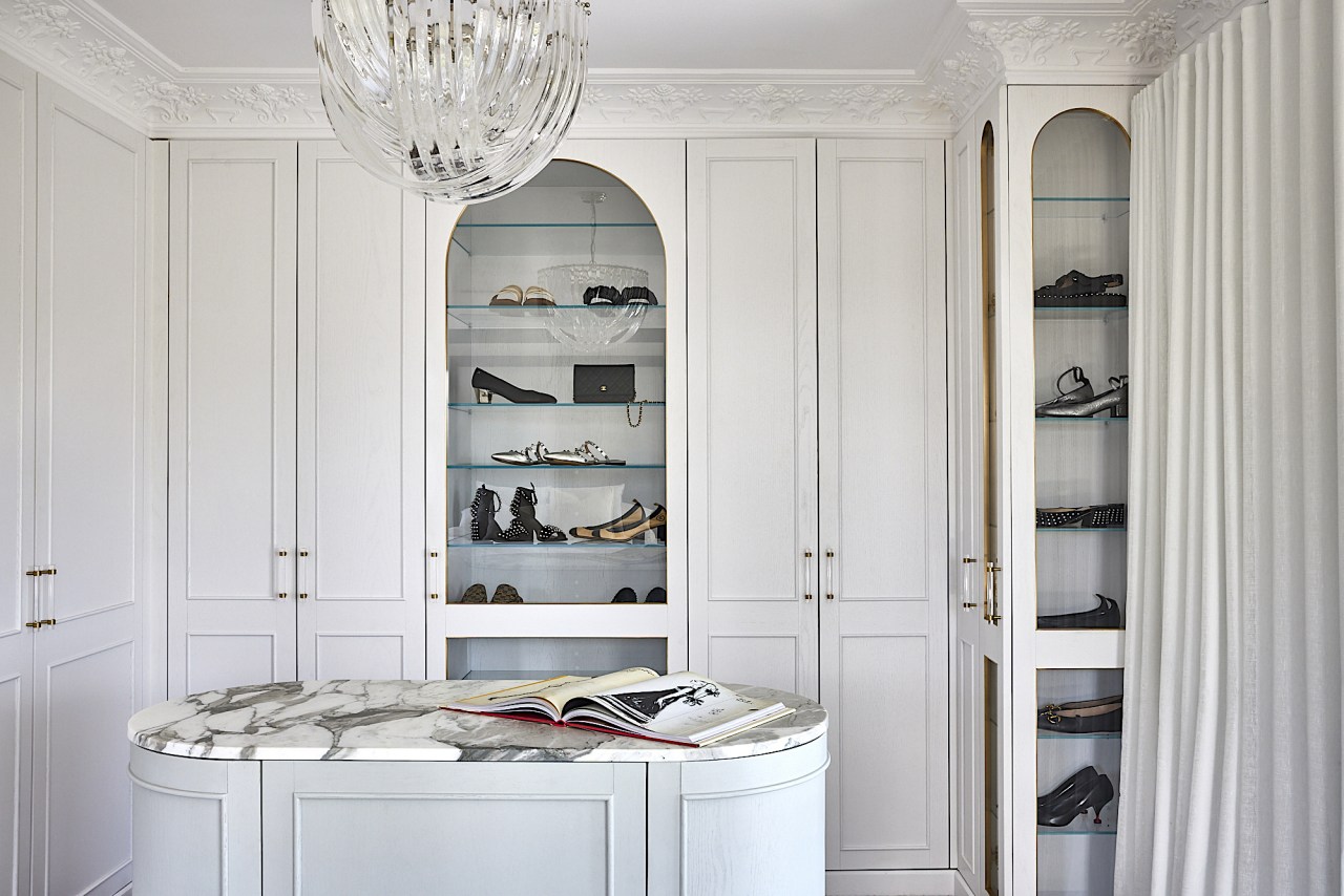 The walk-in dressing room includes display shelving reminiscent 