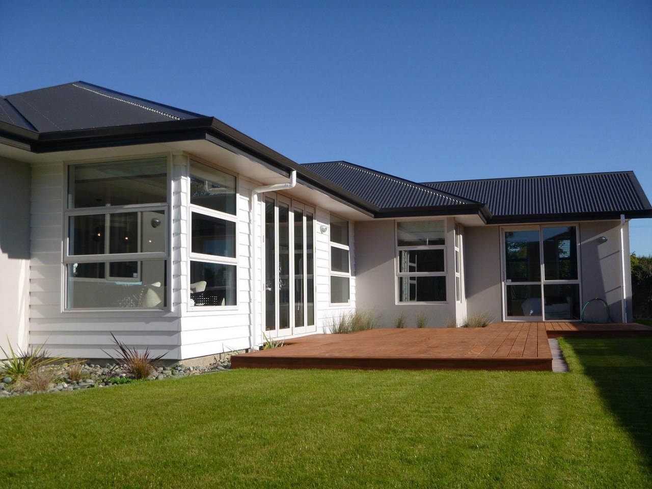Envira timber weatherboards and roughcast on Nelson family backyard, cottage, elevation, estate, facade, farmhouse, home, house, orangery, porch, property, real estate, residential area, roof, siding, window, yard, blue, brown