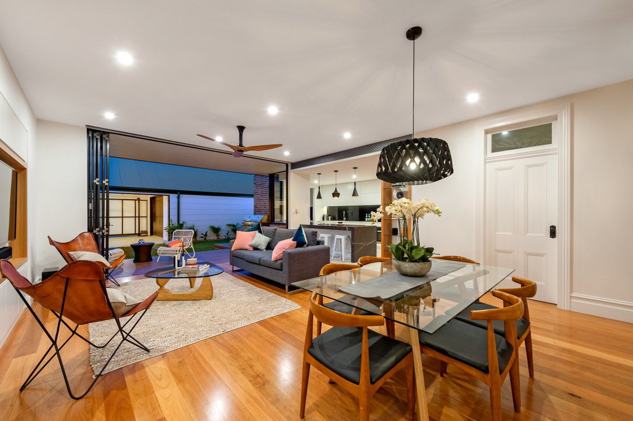 The living room flows out onto the undercover ceiling, dining room, hardwood, home, house, interior design, living room, property, real estate, room, gray