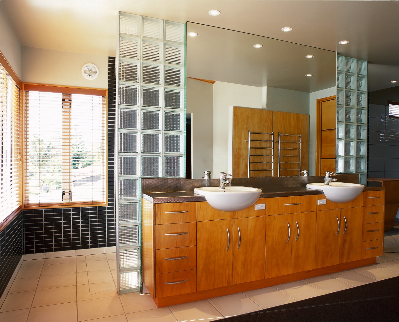 The view of a bathroom featuring glass bricks bathroom, bathroom accessory, bathroom cabinet, cabinetry, countertop, interior design, kitchen, real estate, room, brown