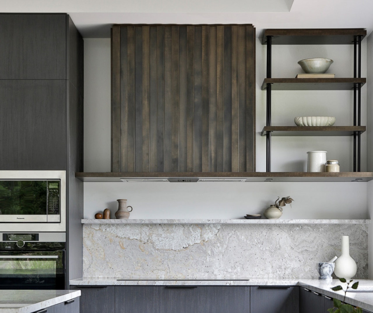 The powder-coated shelving and stone upstand situated above 