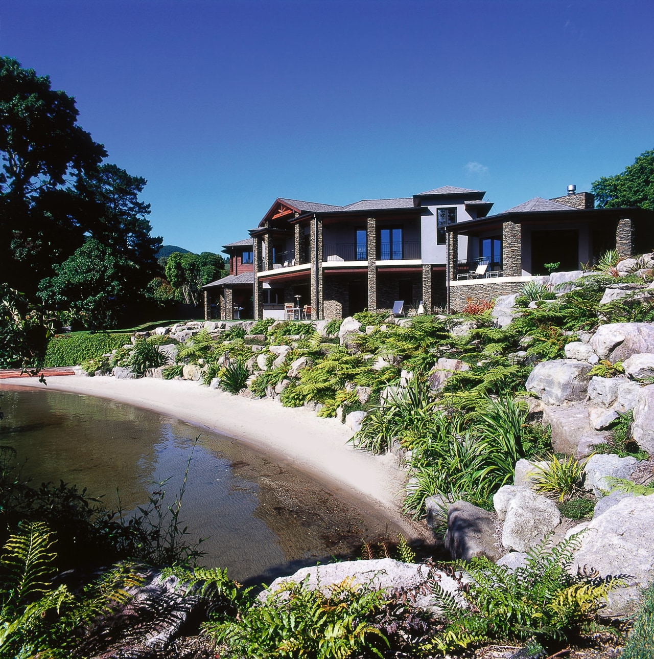 View of the landscape of this home cottage, estate, hacienda, home, house, leisure, mansion, plant, property, real estate, reflection, resort, sky, tree, villa, water