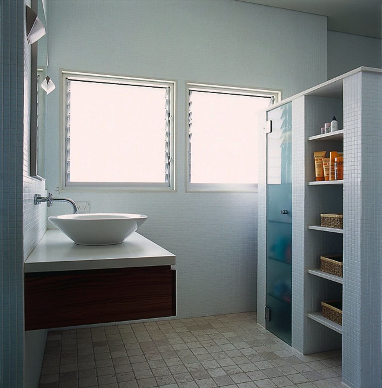 The view of a bathroom featuring a wall bathroom, bathroom accessory, bathroom cabinet, floor, interior design, plumbing fixture, room, sink, gray