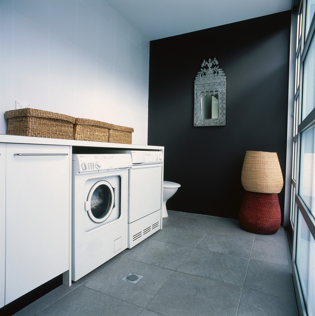 Laundry room with white appliances and cabinetry, toilet clothes dryer, floor, home, home appliance, interior design, laundry, laundry room, major appliance, product, room, washing machine, gray, black