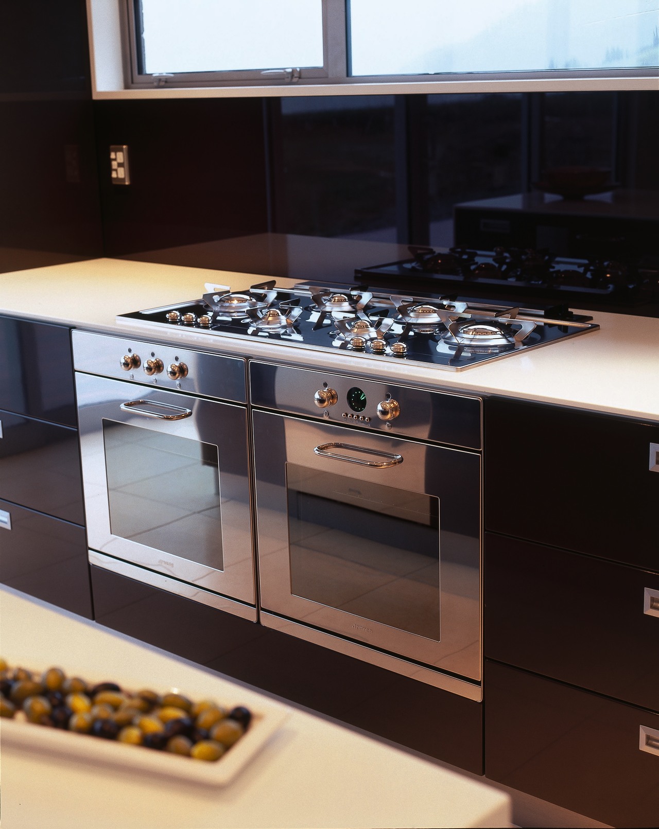 Kitchen with stainless steel ovens and gas hob. countertop, gas stove, home appliance, kitchen, kitchen appliance, kitchen stove, major appliance, black
