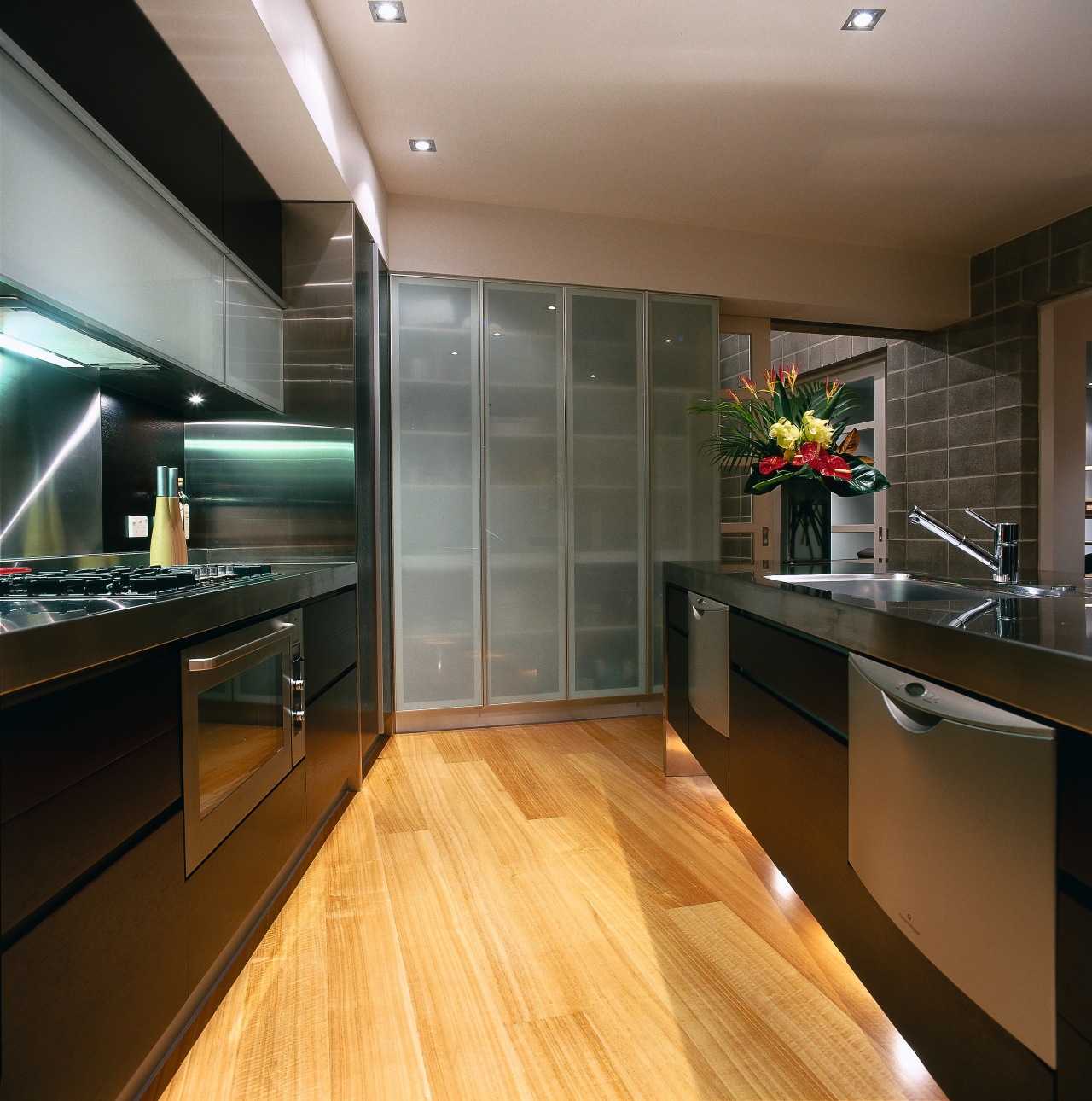 The view of a contemporary kitchen with dark cabinetry, ceiling, countertop, floor, flooring, hardwood, interior design, kitchen, laminate flooring, real estate, room, wood flooring, brown