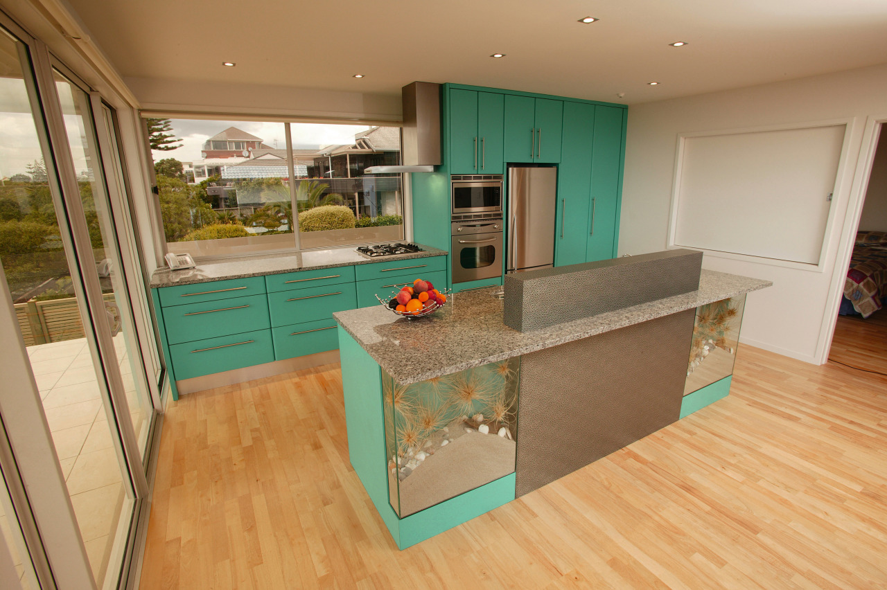 Kitchen with green cabinetry, stainless steel finish refrigerator, countertop, floor, flooring, interior design, kitchen, real estate, room, orange, brown