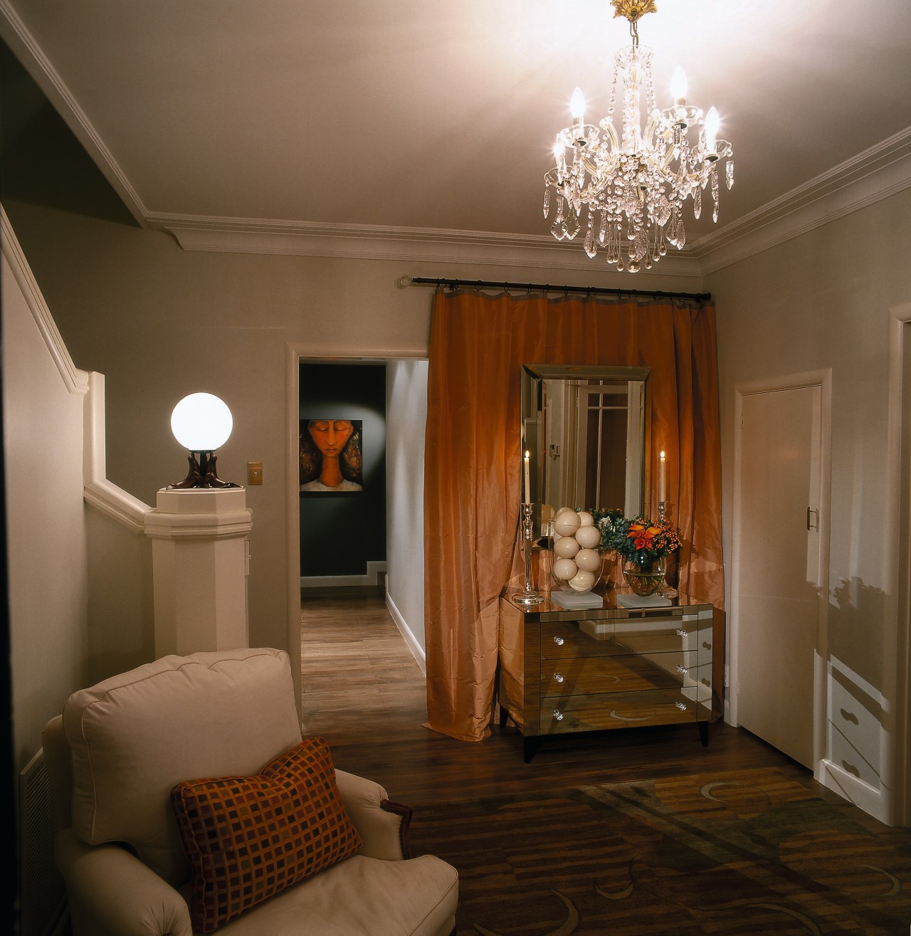 A view of a mirror console with custom ceiling, floor, home, interior design, light fixture, lighting, living room, room, wall, brown