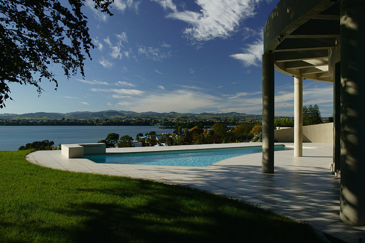 Overlooking the views from this Mediterranean-style house architecture, cloud, estate, home, house, property, real estate, resort, sea, sky, swimming pool, tree, villa, water, black