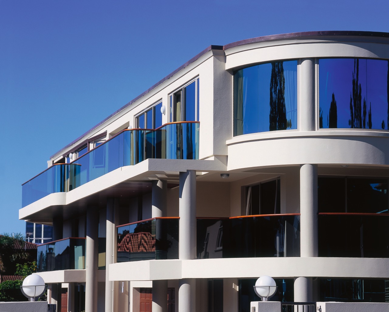 Inner view of a house featuring curved balustrades apartment, architecture, building, commercial building, condominium, corporate headquarters, elevation, facade, home, house, mixed use, property, real estate, residential area, sky, window, blue, black