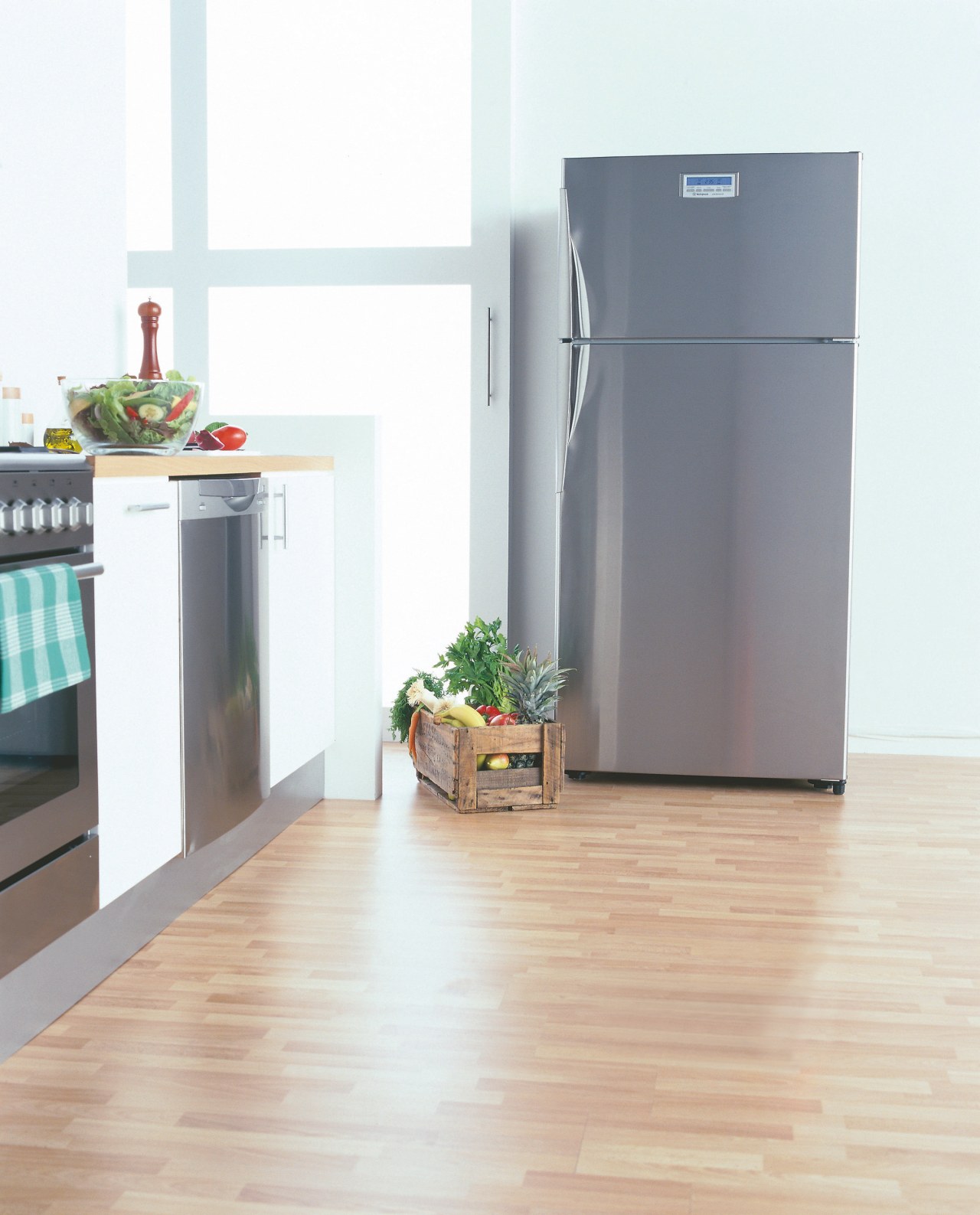 A kitchen featuring a large Westinghouse refrigerator. The floor, flooring, hardwood, home appliance, kitchen appliance, major appliance, product, refrigerator, white