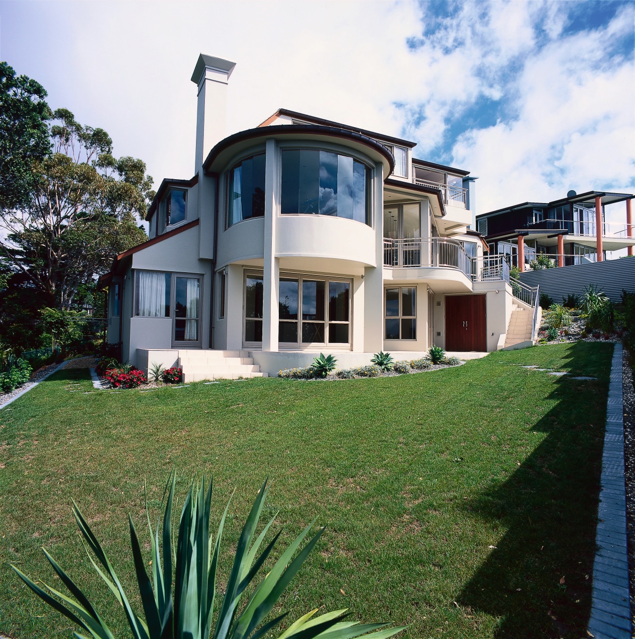 View of the front of a luxury clifftop apartment, building, elevation, estate, facade, home, house, mansion, property, real estate, residential area, sky, villa, window, white