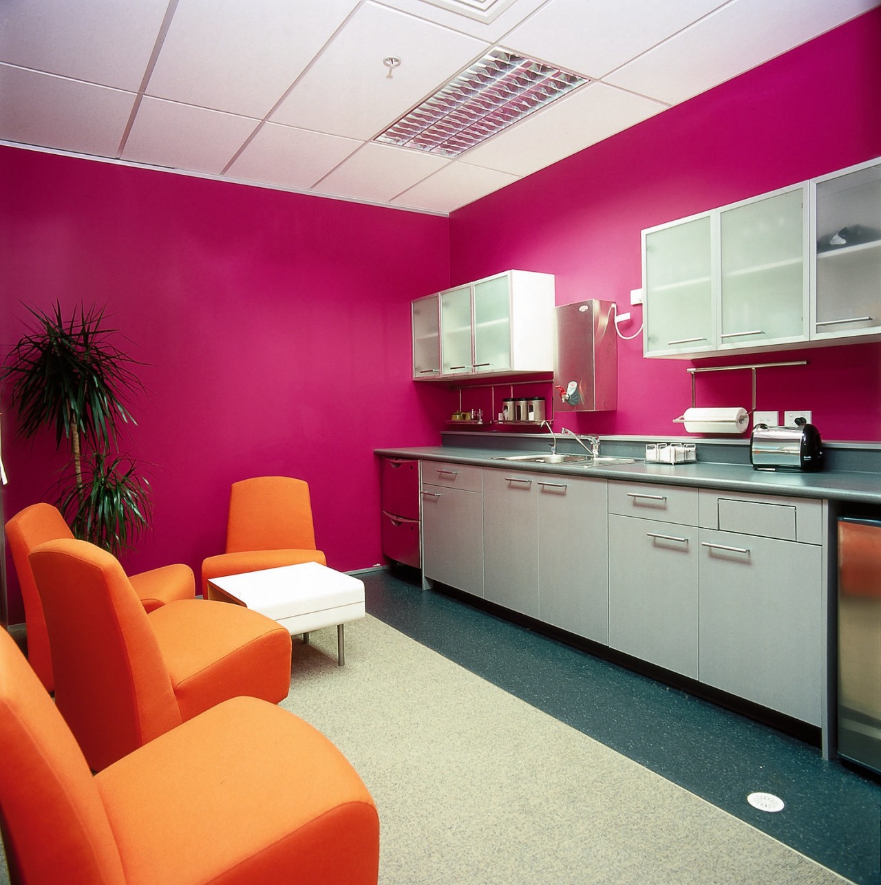 Office kitchen area with pink walls, orange armchairs, ceiling, interior design, office, wall, red