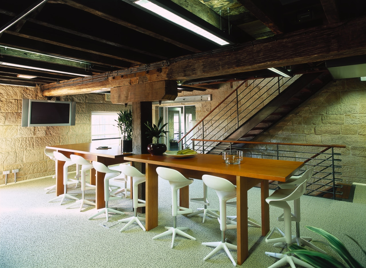 Long timber table in hospitality area with white architecture, furniture, interior design, table, wood, black