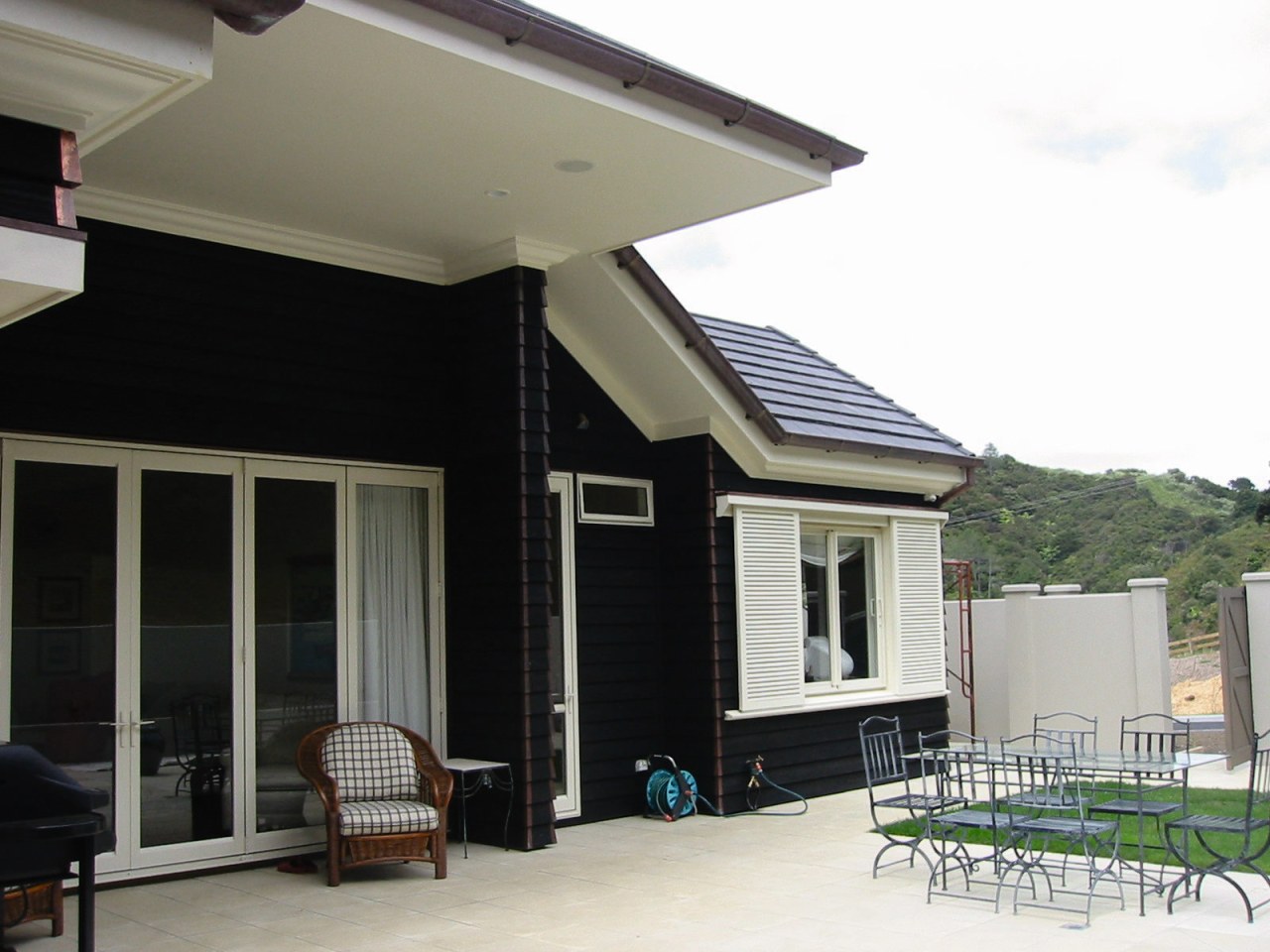 View of the back patio facade, home, house, porch, property, real estate, residential area, roof, siding, window, white, black, gray