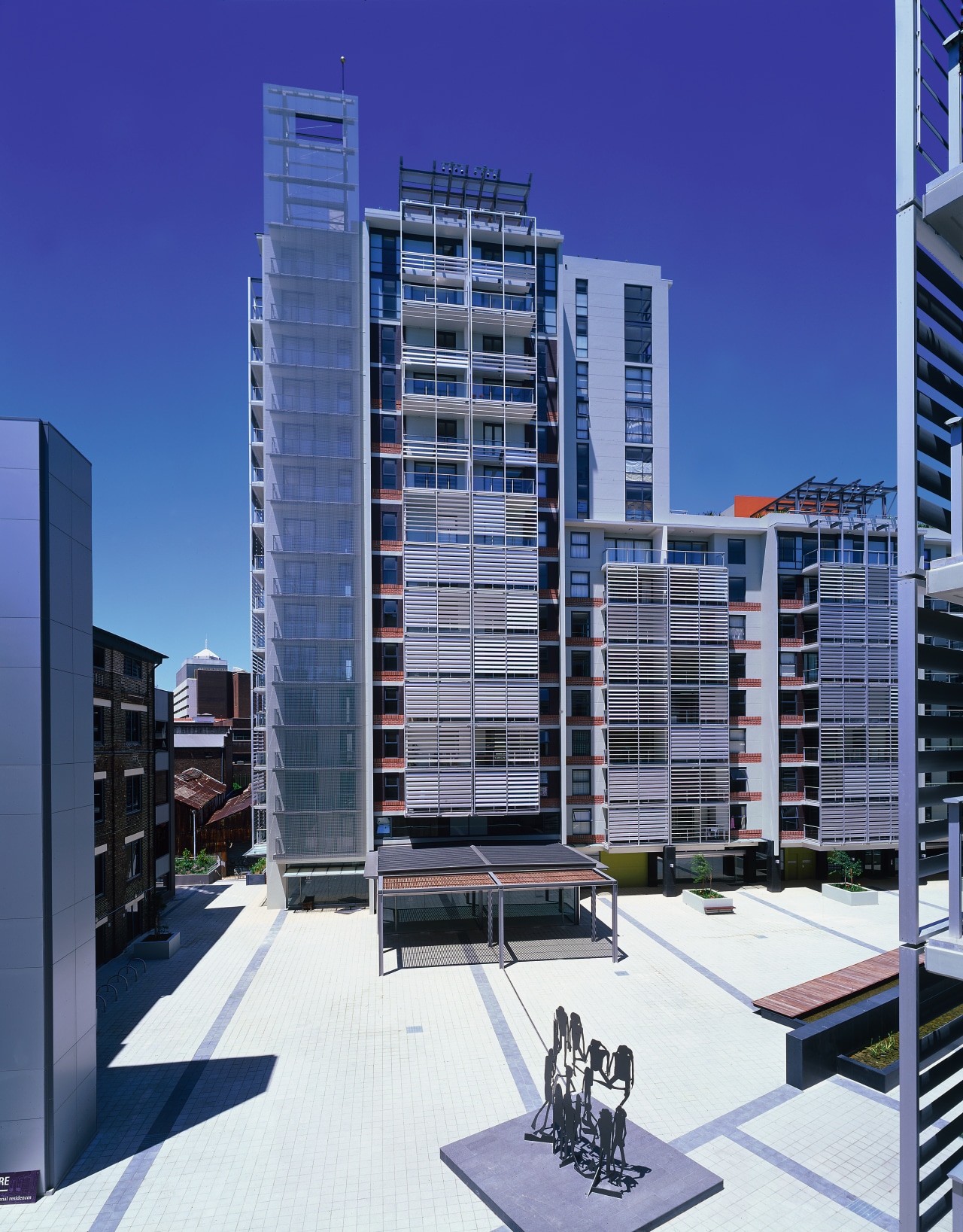 View of apartment and retail complex from paved apartment, architecture, building, city, commercial building, condominium, corporate headquarters, daytime, elevation, facade, headquarters, metropolis, metropolitan area, mixed use, neighbourhood, real estate, residential area, sky, skyscraper, tower block, urban area, urban design, blue