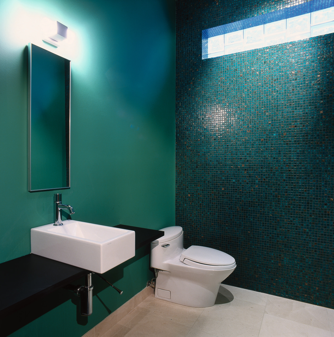 View of this modern bathroom bathroom, blue, floor, glass, interior design, plumbing fixture, product design, public toilet, purple, room, sink, tile, toilet, wall, teal