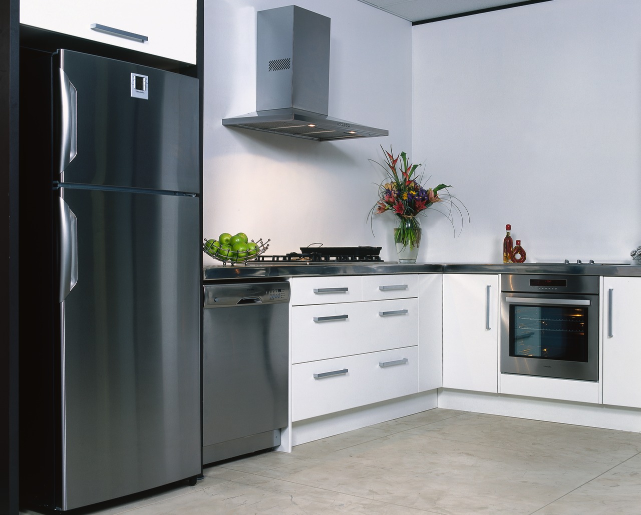 Kitchen with white cabinetry, stainless refrigerator, dishwasher, oven countertop, cuisine classique, home appliance, kitchen, kitchen appliance, kitchen stove, major appliance, product design, refrigerator, gray, black