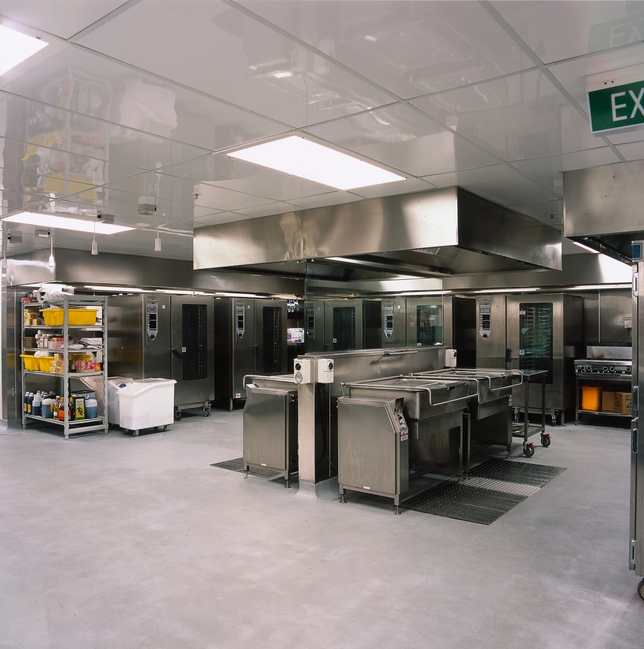 Commercial kitchen with stainless steel equipment including ovens gray