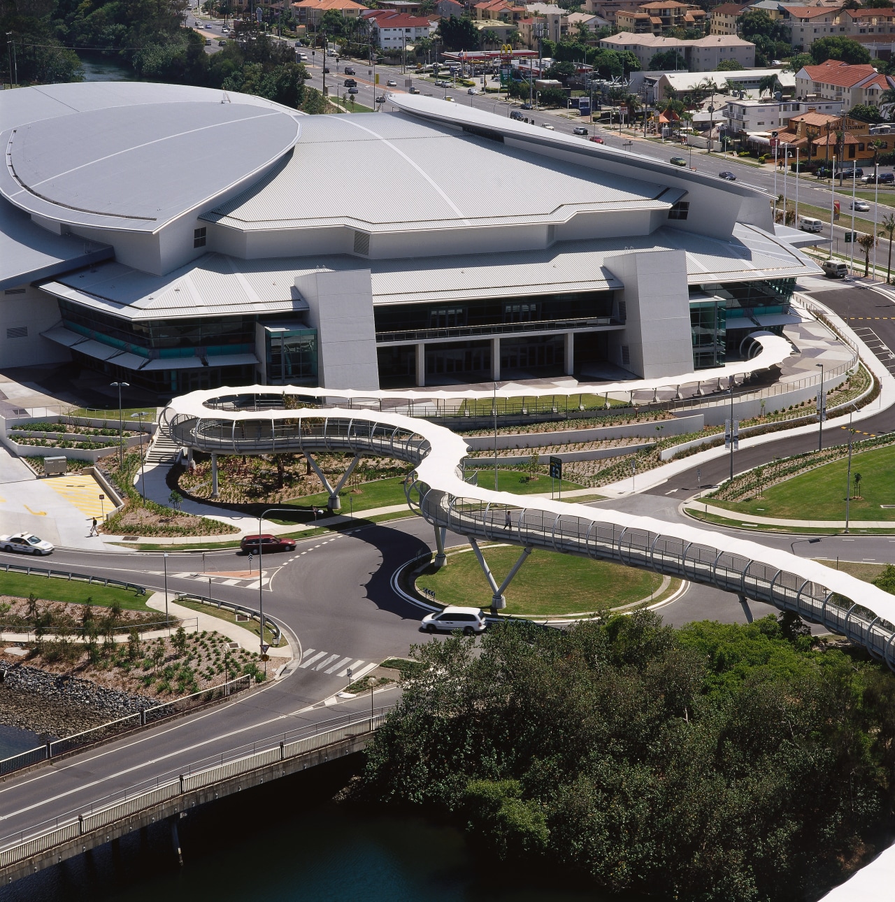 Long snaking pedestrian bridge with white canopy overhead, aerial photography, architecture, bird's eye view, building, city, fixed link, metropolitan area, structure, urban area, urban design, water, black, gray