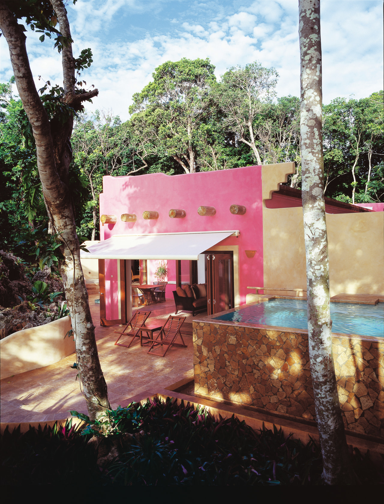 Pink coloured hotel room with awning over outdoor cottage, hacienda, home, house, property, real estate, resort, black