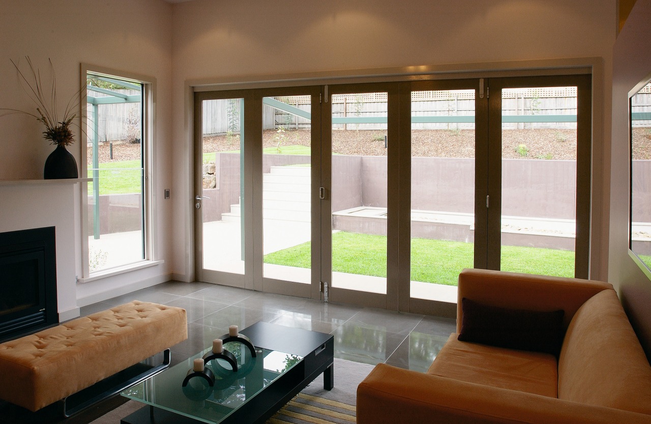 Lounge room with timber framed bifold doors leading ceiling, daylighting, door, interior design, living room, real estate, shade, window, window blind, window covering, window treatment, wood, brown