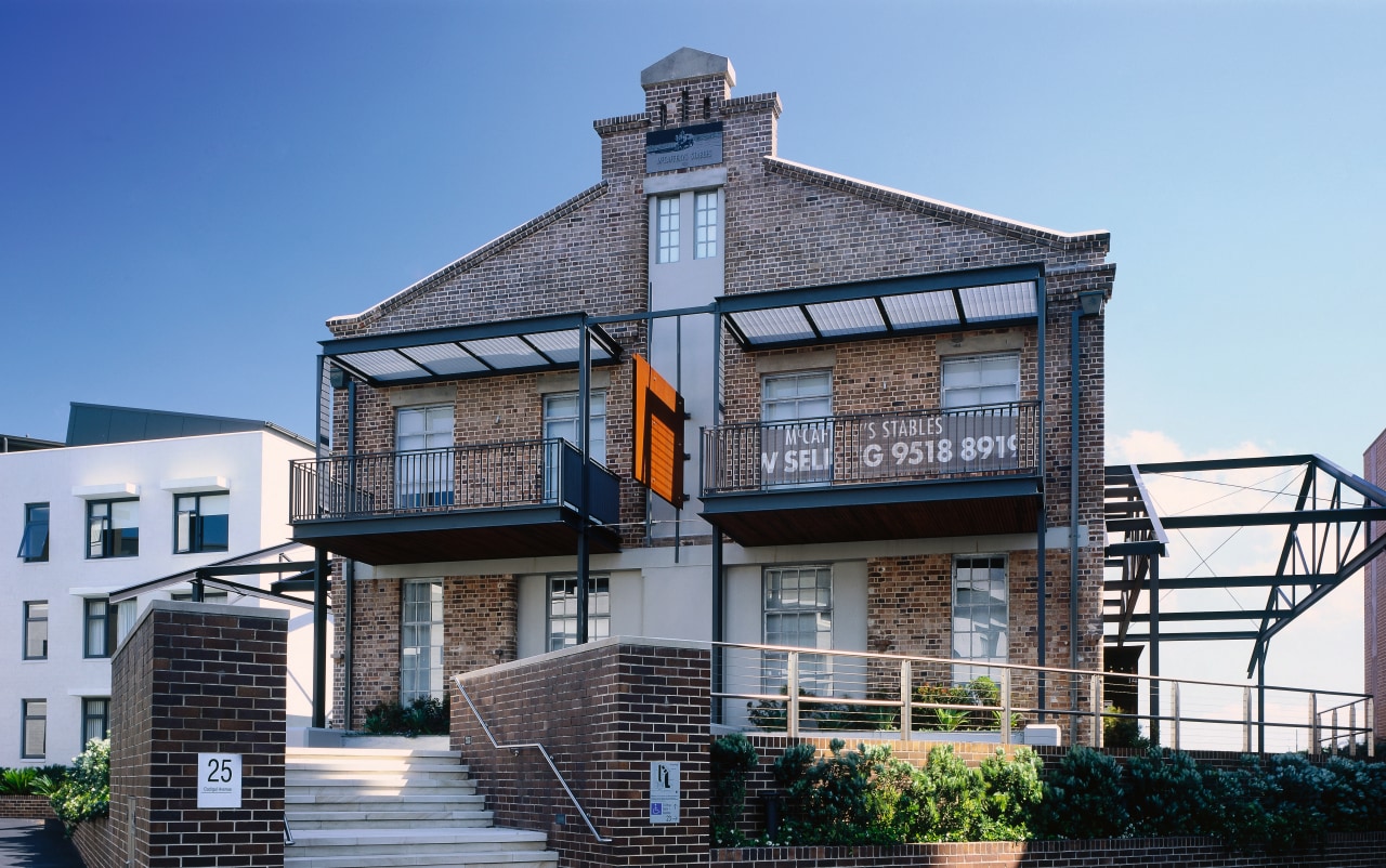 View of a large brick house, many steel building, condominium, facade, home, house, mixed use, property, real estate, residential area, teal