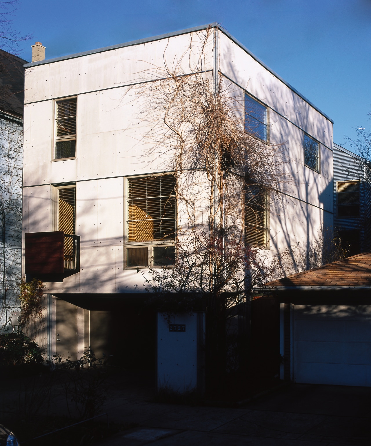 Exterior view of a white cubic house, many apartment, architecture, building, facade, home, house, neighbourhood, real estate, reflection, residential area, sky, wall, window, black