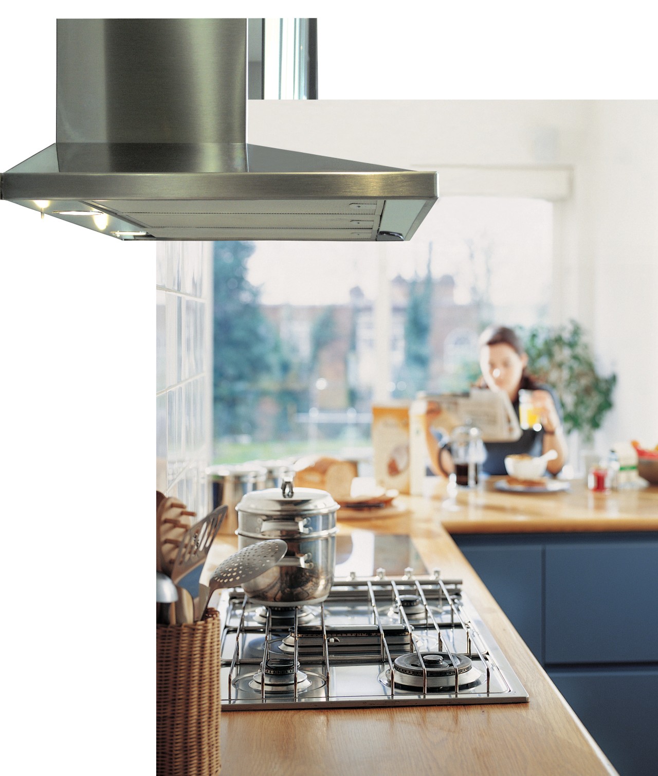 Kitchen showing rangehood mounted over kitchen island, with furniture, interior design, kitchen, kitchen appliance, table, white