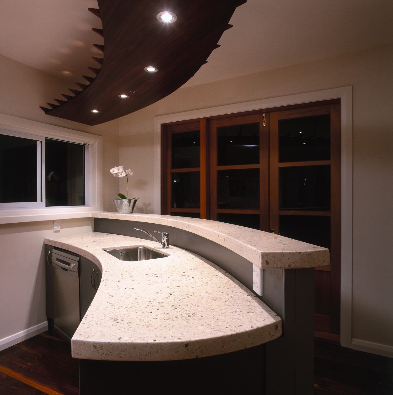 Curved polished concrete kitchen benchtop and breakfast bar, cabinetry, ceiling, countertop, interior design, lighting, room, under cabinet lighting, black, brown