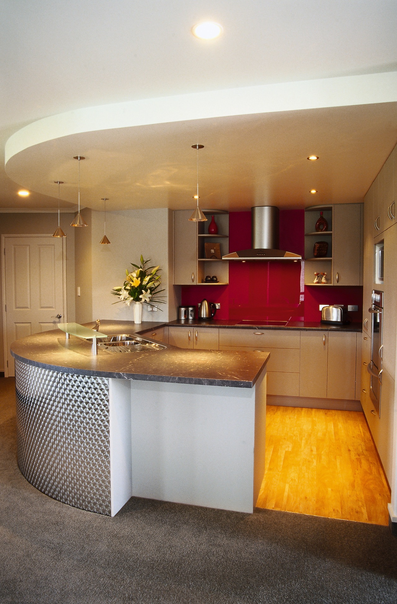 Kitchen with curved cabinetry with patterned panels, marble architecture, cabinetry, ceiling, countertop, interior design, kitchen, real estate, room