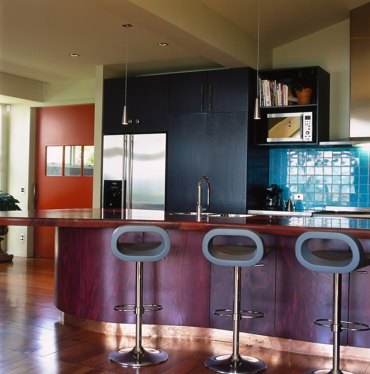 Kitchen with bar stools at island. cabinetry, ceiling, countertop, interior design, kitchen, table