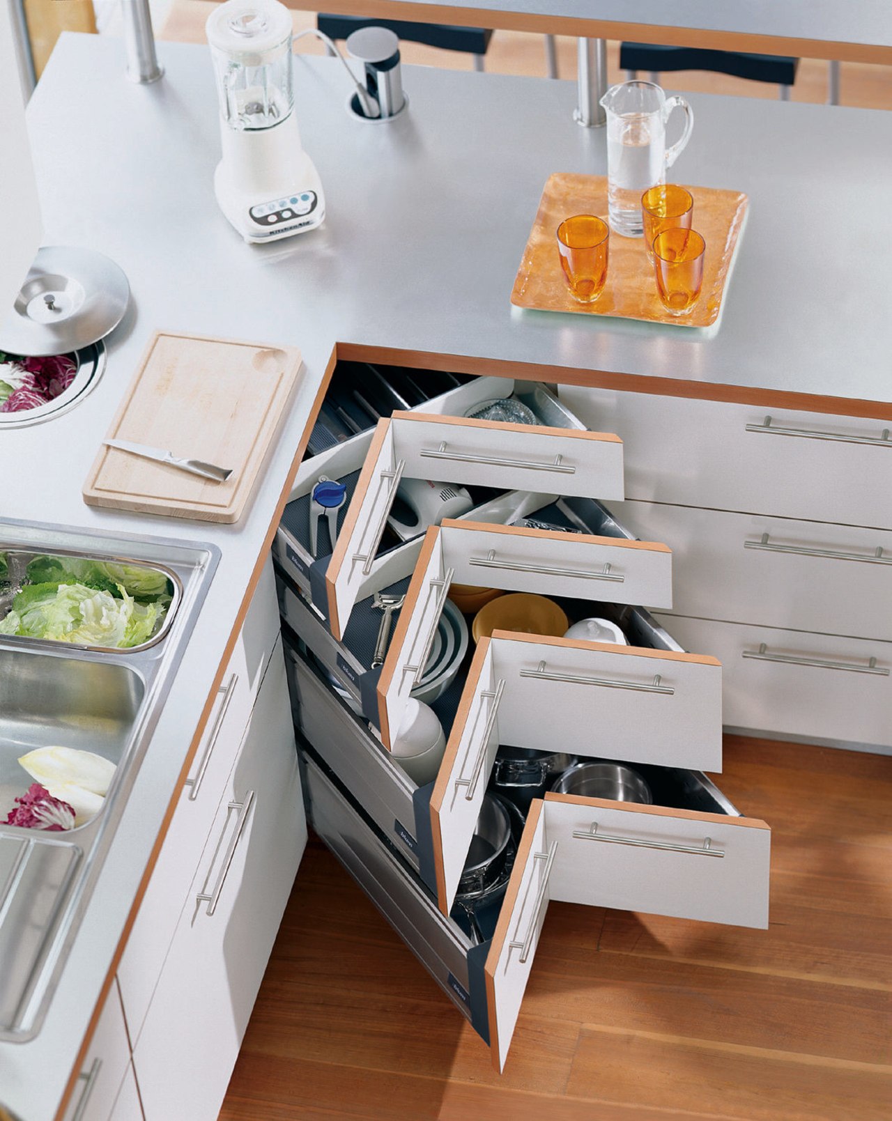 A view of a kitchen area, wooden flooring, drawer, furniture, kitchen, product design, shelf, shelving, table, gray