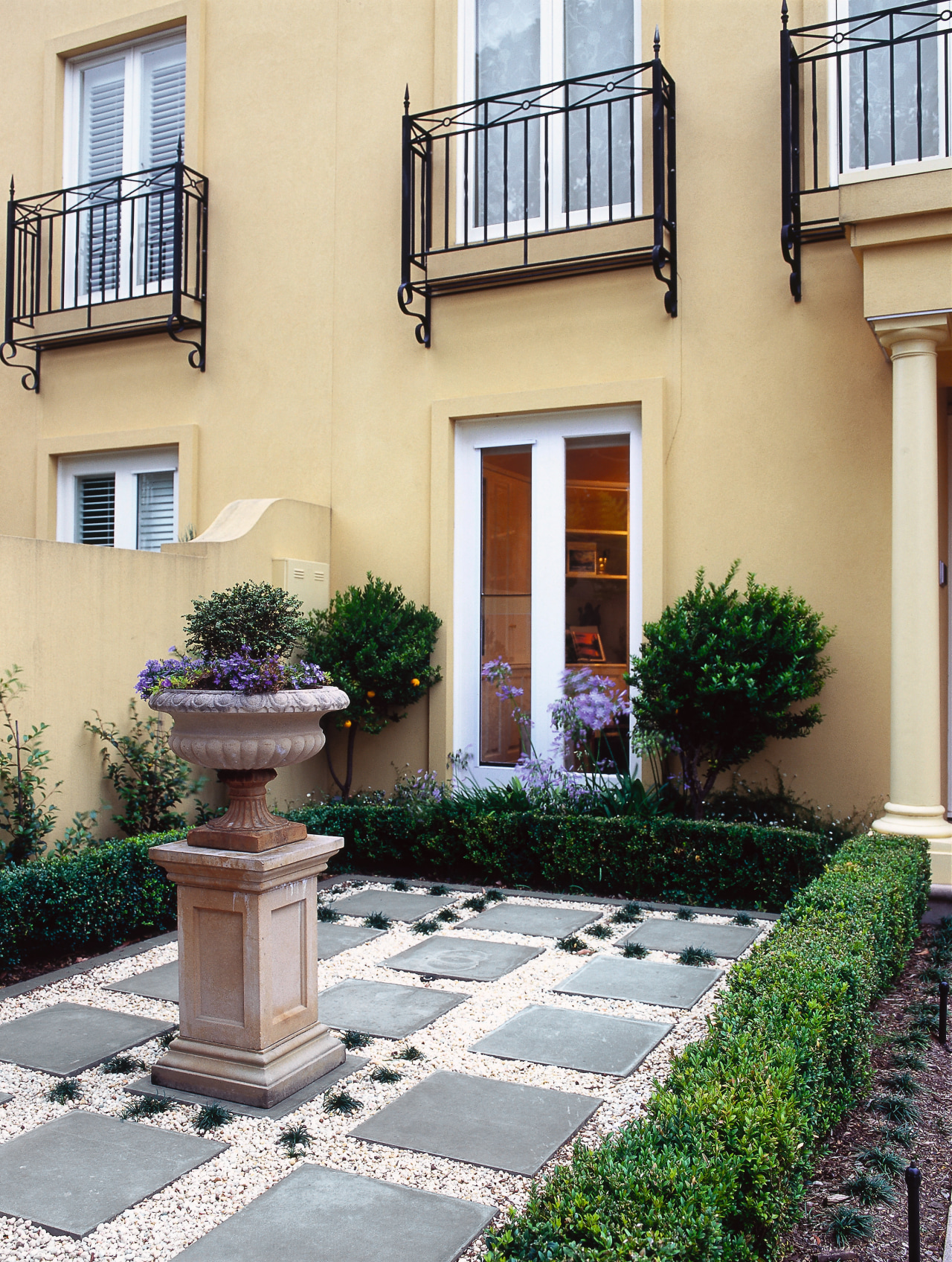 View of the courtyard area, many concrete slabs courtyard, estate, facade, garden, home, house, landscaping, neighbourhood, property, real estate, residential area, walkway, window, orange