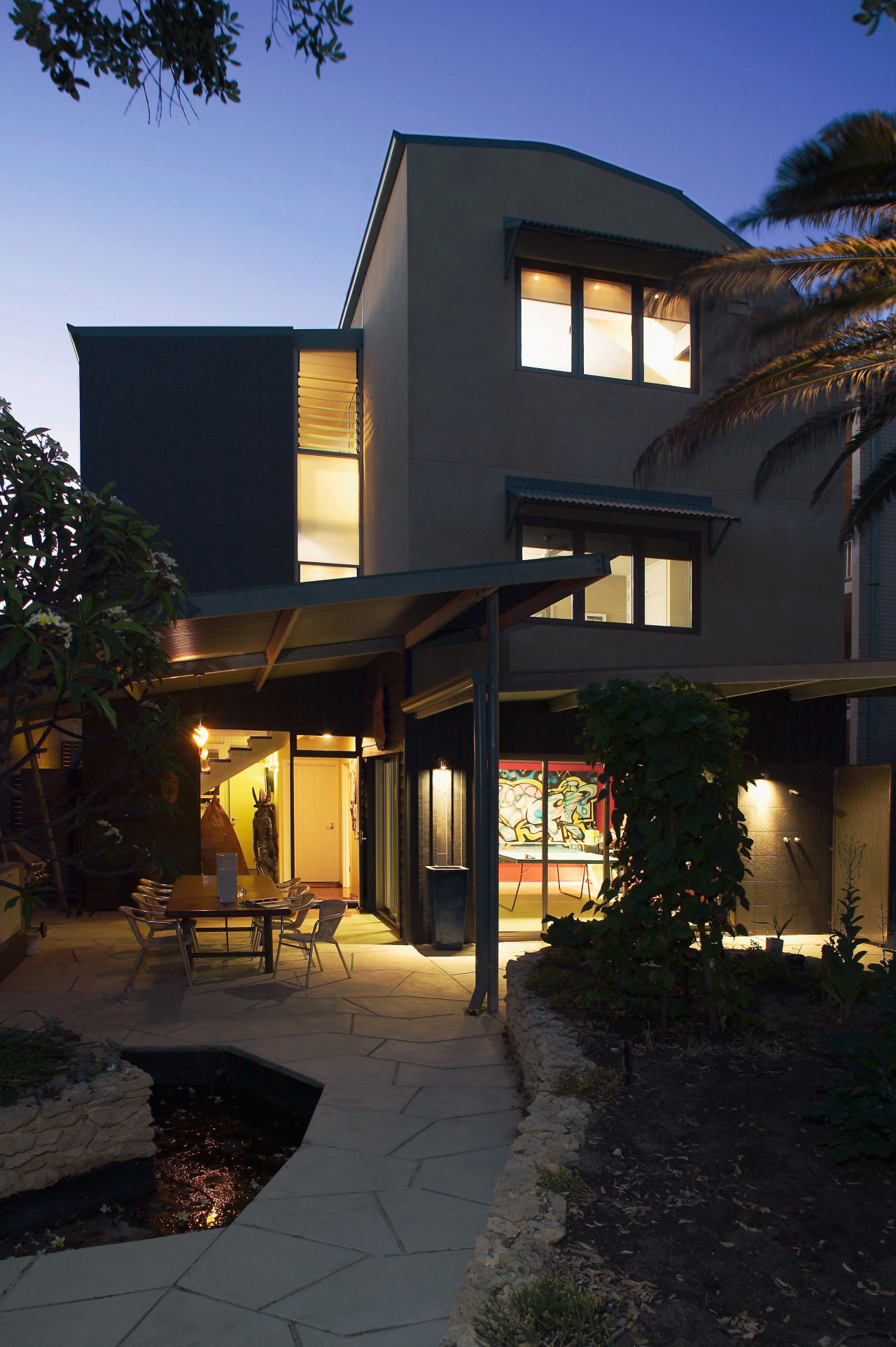 view of the back of the house showing apartment, architecture, building, courtyard, elevation, estate, facade, home, house, landscape lighting, lighting, mixed use, property, real estate, residential area, window, black