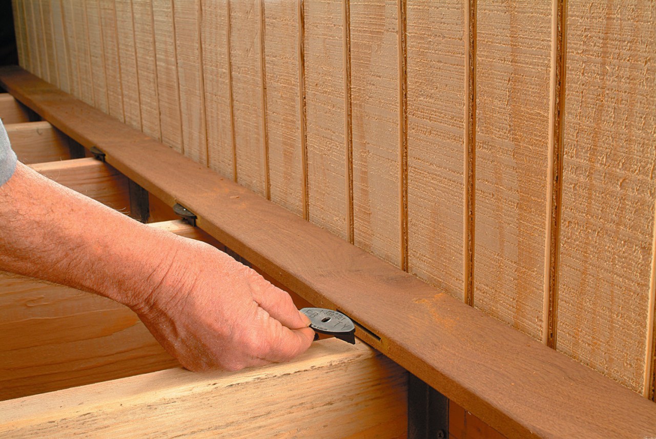Close up view of the fastening system on floor, flooring, hardwood, line, lumber, material, plywood, wall, wood, wood stain, orange, brown