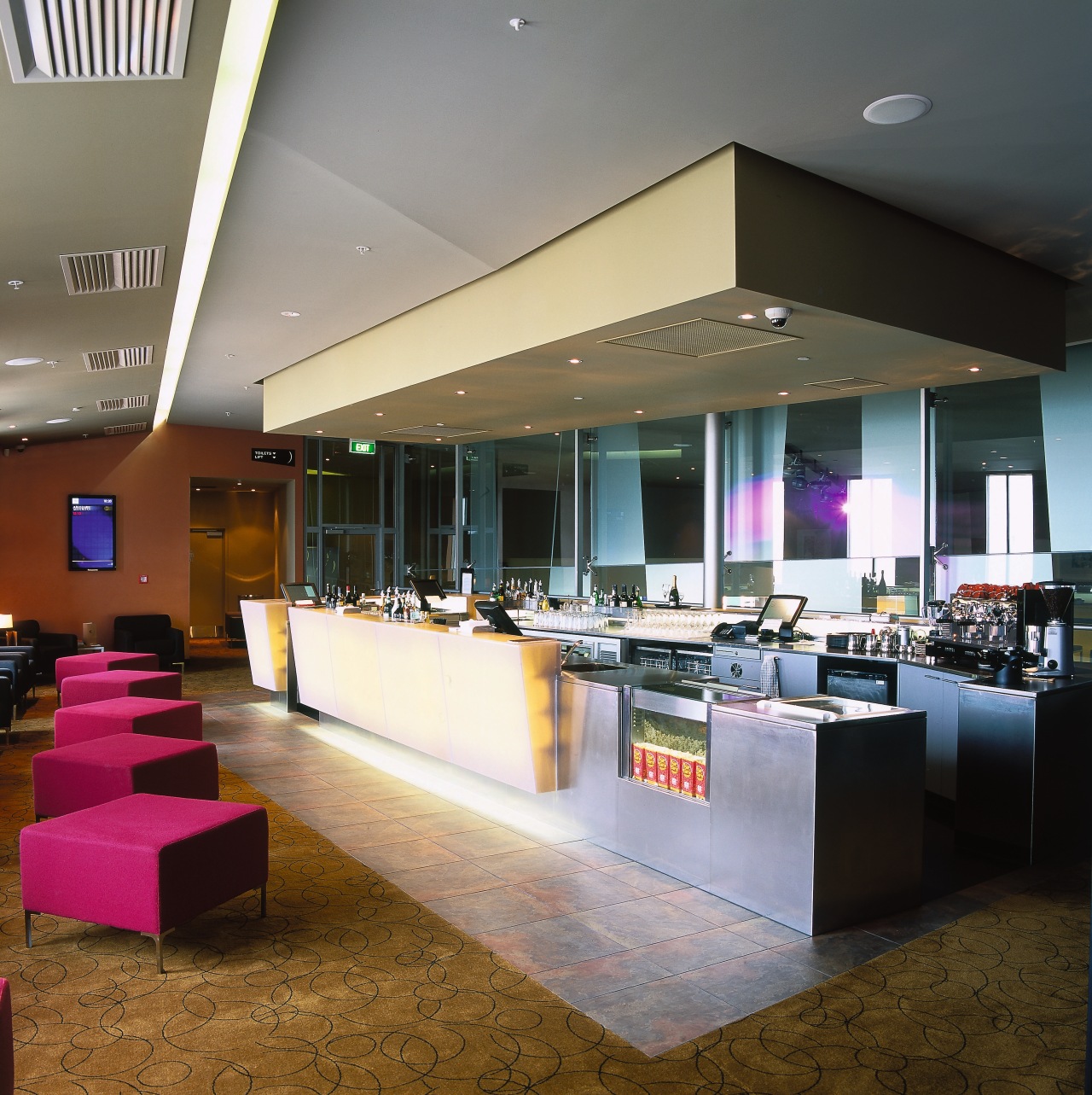 Retail bar area with pink seats, carpet and ceiling, interior design, lobby, restaurant, gray, brown