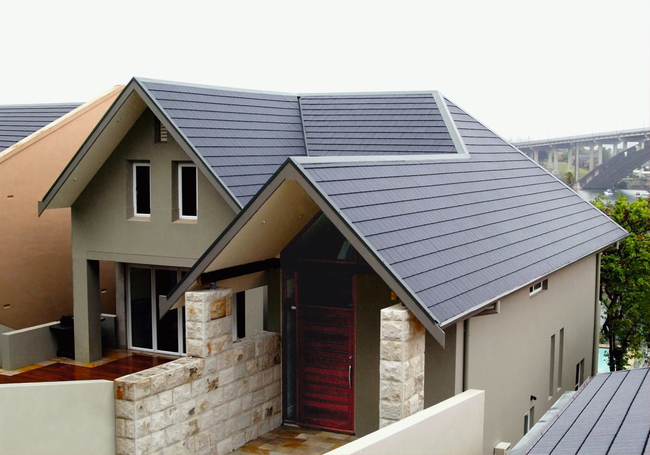 Exterior view of front of house with tan daylighting, facade, home, house, property, real estate, roof, siding, gray