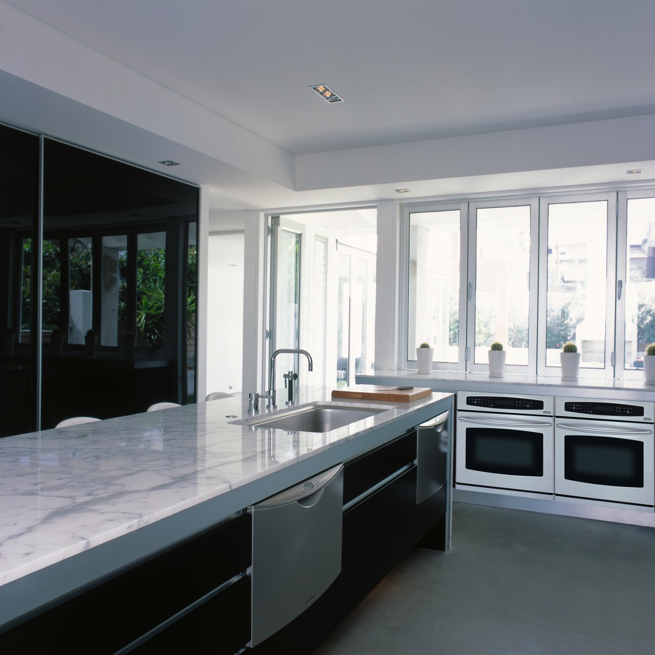 View of a kitchen, polished concrete flooring, marble cabinetry, countertop, cuisine classique, interior design, kitchen, real estate, window, gray, black